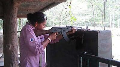 The writer tries firing an AK47 during a visit to the Cu Chi tunnels outside Ho Chi Minh City.