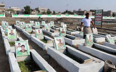 A Yemeni men walks among graves of men said to be killed in the country’s ongoing war, at a cemetery in the Yemeni Red Sea city of Hodeida, on January 18, 2021. AFP