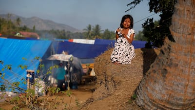 A girl cries as she waits for breakfast at a refugee camp at Sigar Penjalin village in North Lombok, Indonesia, August 10, 2018. Reuters