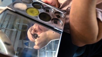 Sloth performer Ren Carter does her make-up before the show
