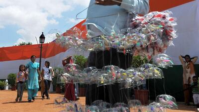 Indian families walk past a street vendor at the India Gate monument in New Delhi during Independence day celebrations on August 15, 2012. Roberto Schmidt / AFP Photo