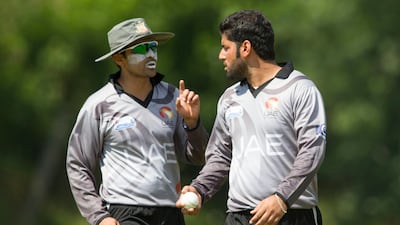 With the cushion of 269 runs, Mohammad Naveed, right, bowled an attacking line and unsettled the Canada batsmen. Here, he is seen taking instructions from Khurram. Chris Young / The National