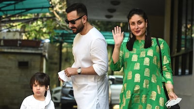 Bollywood actors Saif Ali Khan (C) and Kareena Kapoor Khan (R) with their son Taimur Ali Khan arrive for a Christmas brunch on Christmas Day in 2020. AFP