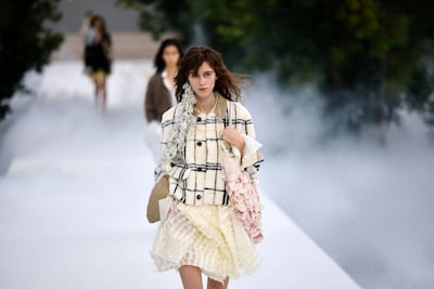 Long scarves, cascading earrings and draped fabrics reinforce the collection’s interest in asymmetry. Reuters