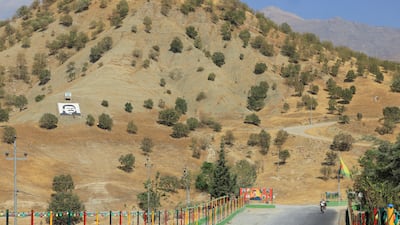 A portrait of jailed Kurdistan Workers Party leader Abdullah Ocalan, alias Apo, and the salutation 'Serok Apo' are displayed on a hillside in the Qandil mountains, Iraq, on October 26. Reuters