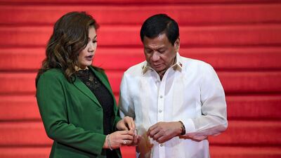 Rodrigo Duterte chats with partner Honeylet Avancena while waiting for leaders to arrive to attend the opening ceremony of the ASEAN summit in Manila on April 29, 2017. AFP