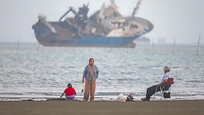 Iranians sit on Suru Beach in Bandar Abbas along the Strait of Hormuz. AFP