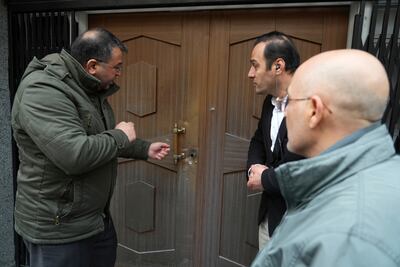 A man examines bullet holes after an attack at the Azerbaijan embassy in Tehran on Friday, where the head of security at the diplomatic post was killed and two guards wounded. AP Photo