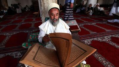 A Yemeni Muslim worshipper reads the Koran, Islam's holy book, at the Great Mosque in the old city of the capital Sanaa, during the holy fasting month of Ramadan. Mohammed Huwais / AFP