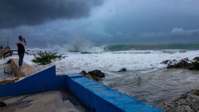 Photographing the crashing waves as Hurricane Ian tears through George Town, Grand Cayman. AP Photo