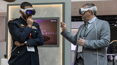 Visitors view TAWAZUN VR training goggles at the event. Antonie Robertson/The National