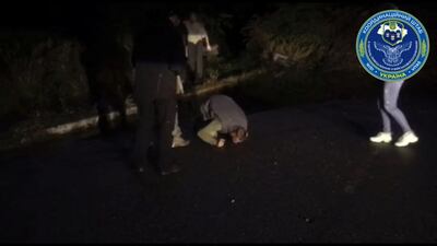 A Ukrainian prisoner of war kisses the ground after he was released in a swap with Russia. Reuters