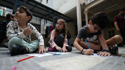 Children who fled Israeli bombardment in southern Lebanon, attend a drawing workshop organised by volunteers, at a shelter in Beirut. AFP