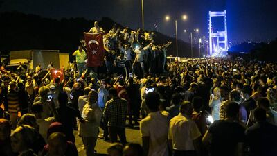 File photo taken on the July 15 coup showing people take to the streets near the Fatih Sultan Mehmet bridge during clashes with military forces in Istanbul. Gurcan Ozturk/AFP