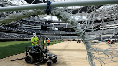 Workers install turf at the LA Stadium in California. Reuters