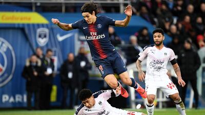 PSG's Edinson Cavani is tackled by Pablo, of Bordeaux, during the Ligue 1 match at the Parc des Princes stadium in February, 2019. AFP