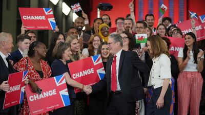 Labour Party leader Keir Starmer shakes hands with his supporters at the Tate Modern in London, Friday, July 5, 2024. Labour Party Starmer says voters "have spoken and they are ready for change" as an exit poll points to landslide win, and is expected to be the next British Prime Minister. (AP Photo / Kin Cheung)