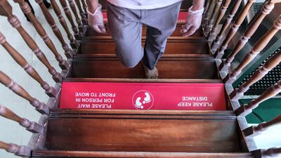 Markings on the floor of a Shiva temple in Dubai remind worshippers to maintain physical distancing. Reem Mohammed / The National