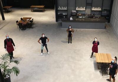 The restaurant at Inked is empty but its kitchens are not. Here, the five-person team who have been provided 100 meals a day. Co-owners Kenza and Patrick Jarjour are at the right.