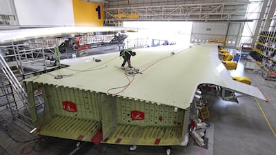 An employee inspects the surface of an Airbus A380 wing during production at the Airbus SAS factory in Broughton, UK. Bloomberg