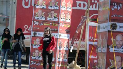 Young women in Amman walk past campaign posters for Jordan’s parliamentary elections on September 20, 2016. Khalil Mazraawi / AFP / Spetember 14, 2016