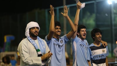 Man City fans celebrate during a free screening of the game against West Ham at Zayed Sports City in Abu Dhabi. Fatima Al Marzooqi / The National