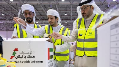 Volunteers pack aid for Lebanon at the Sharjah Expo Centre in October. Ahmed Ramzan for The National