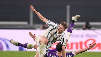 Matthijs de Ligt, top, and Dusan Vlahovic tussle during the match. AP
