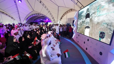 People attend a live screening of the launch of the UAE's first astronaut into space, at Mohammed bin Rashid Space Centre in Dubai. Chris Whiteoak / The National