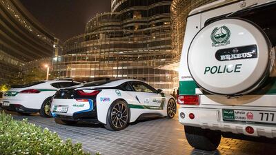 From left, a Porsche Panamera, BMW i8 hybrid sports car and a Brabus 700, all in the Dubai Police colours, pictured in 2015. Dubai Police