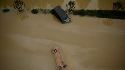 Cars sit in floodwaters following heavy rains, in Zhengzhou in China's central Henan province.