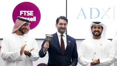 Khalid Bin Shaiban Al Muhairi , Chairman of ADX , Waqas Samad, chief executive of FTSE Russell and Khalifa Salem Al Mansouri, chief executive of ADX after signing cooperation agreement on Wednesday. Pawan Singh / The National