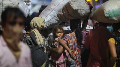 Migrant workers line up to board trains to their home states, at the railway station in Hyderabad, May 23. Mahesh Kumar A / AP