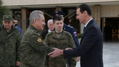 Mr Shoigu, left, is received by Syrian President Bashar Al Assad, right, in Damascus. EPA