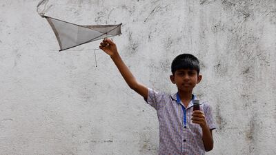 Oshada Fernando, 11, plays with a kite his uncle made for him. 'With the economic crisis we haven't bought any toys for our son,' said his mother, 42-year-old Anusha Priyadarshini.