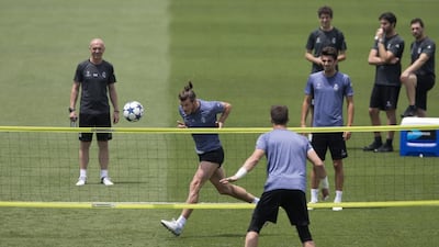 Bale heads a ball during the training session. Paul White / AP photo
