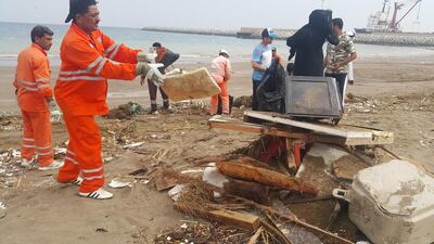 Fishermen, students and residents gather after fishermen cleared 50 tonnes of rubbish over a two-day period. They found clothes, shoes and even TV screens during the clean-up. Ruba Haza / The National