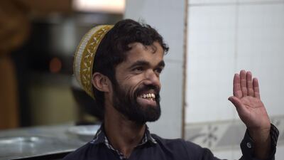 Rozi Khan waves to customers at Dilbar Hotel in Rawalpindi. AFP