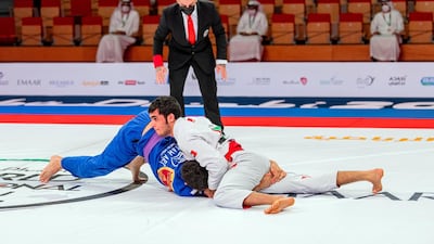 Omar Al Fadhli, in white, has Macley Silva pinned in the 62-kg purple belt final at the Abu Dhabi World Professional Jiu-Jitsu Championship at the Jiu-Jitsu Arena on Thursday, April 8, 2021. Courtesy UAEJJF