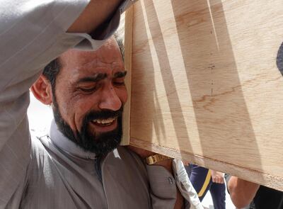 Iraqis mourn relatives killed during a fire in a hospital in the capital, during a funeral procession in Najaf, April 25. AFP