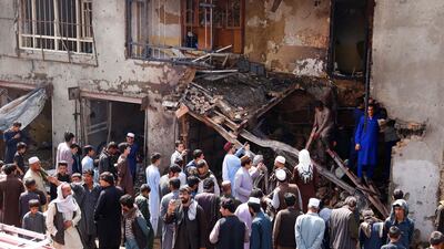 Local residents inspect the scene of a suicide bomb attack that targeted the National Directorate of Security (NDS) convoy in the Bagh Dawood area of Kabul, Afghanistan, 26 July 2018. EPA
