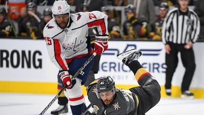 Vegas Golden Knights left wing Pierre-Edouard Bellemare falls to the ice while controlling the puck away from Washington Capitals right wing Devante Smith-Pelly during the first period of play at T-Mobile Arena. Stephen R. Sylvanie / USA TODAY