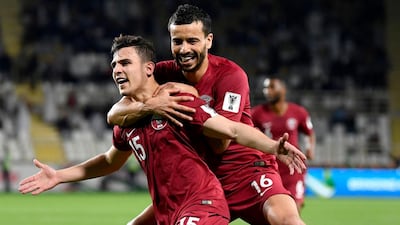 Qatar's defender Bassam Al Rawi (L) celebrates his goal during the 2019 AFC Asian Cup Round of 16 football match between Qatar and Iraq on January 22, 2019. AFP