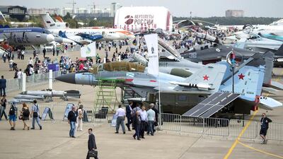 People walk past Russian aircraft on display at the MAKS 2015. Pavel Golovkin / AP Photo