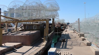 Gargoor fishing traps, which target depleted stocks, on boats at Mina Zayed, Abu Dhabi. John Dennehy / The National