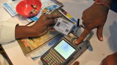 An Indian visitor gives a thumb impression to withdraw money from his bank account with his Aadhaar or Unique Identification (UID) card during a Digi Dhan Mela, held to promote digital payment, in Hyderabad on January 18, 2017. Noah Seelam/AFP
