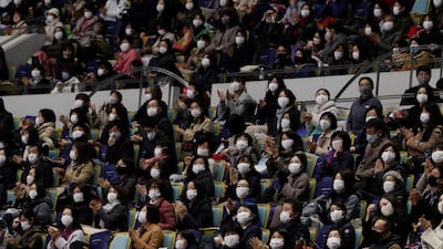 Spectators wearing face masks looks towards an electric board for performance results during a free skating of an ISU Grand Prix of Figure Skating competition in Kadoma near Osaka, Japan. AP Photo