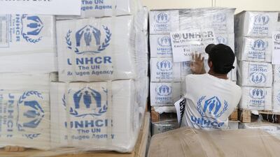 UNHCR staff load pallets of supplies into 31 containers destined for relief efforts in Syria and surrounding countries, where millions have been displaced since the civil war broke out four years ago. Antonie Robertson / The National