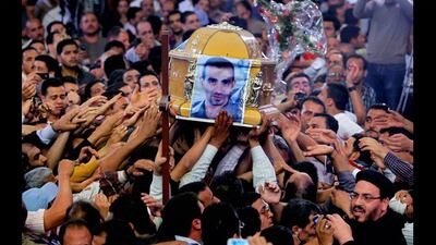 Egyptian Christians carry the coffin of Morqos Kamal, at the Saint Mark Coptic cathedral. Several Egyptians including four Christians and a Muslim were killed in sectarian clashes before dawn in Qalubiya, just outside of Cairo, Egypt. Amr Nabil / AP Photo