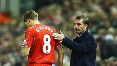 Steven Gerrard, left, of Liverpool prepares to come onto the pitch as a substitute as Brendan Rodgers manager of Liverpool looks on during the Premier League match between Liverpool and Stoke City at Anfield on November 29, 2014 in Liverpool, England. (Photo by Richard Heathcote/Getty Images)